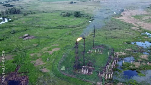 Oil and gas industry. Refining and pumping of oil and gas. Combustion of associated gas. Torch at the oil station. The video was made from a drone.