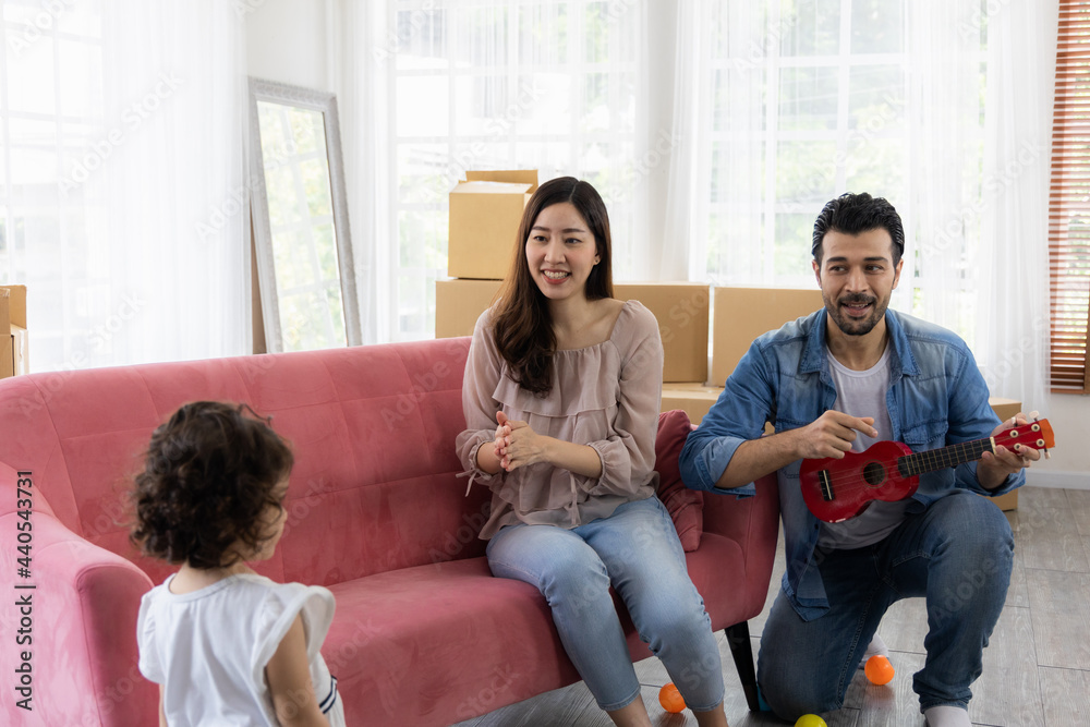 Happy family moment in the house. Father mother and daughter relaxing on red sofa. The family just moving in new house. Happy family moment in the house. Father mother and daughter relaxing on red sofa. The family just moving in new house.