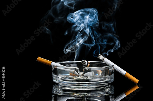 Ash tray with burning cigar...