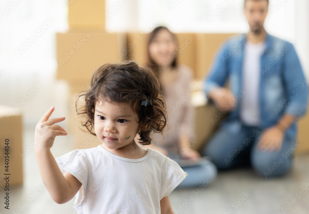 Cute daughter with parent. Happy family in living room. Moving new house a lot of parcel box. Father mother and daughter relax together at home. Cute daughter with parent. Happy family in living room. Moving new house a lot of parcel box. Father mother and daughter relax together at home.