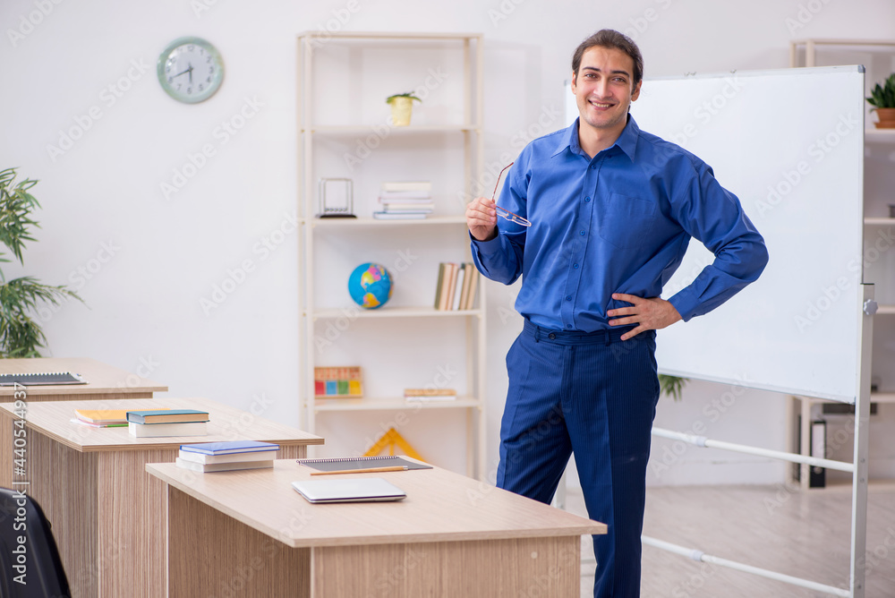 Young male teacher in front of white board Young male teacher in front of white board