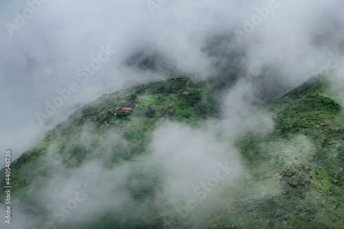 Green mountains covered in clouds