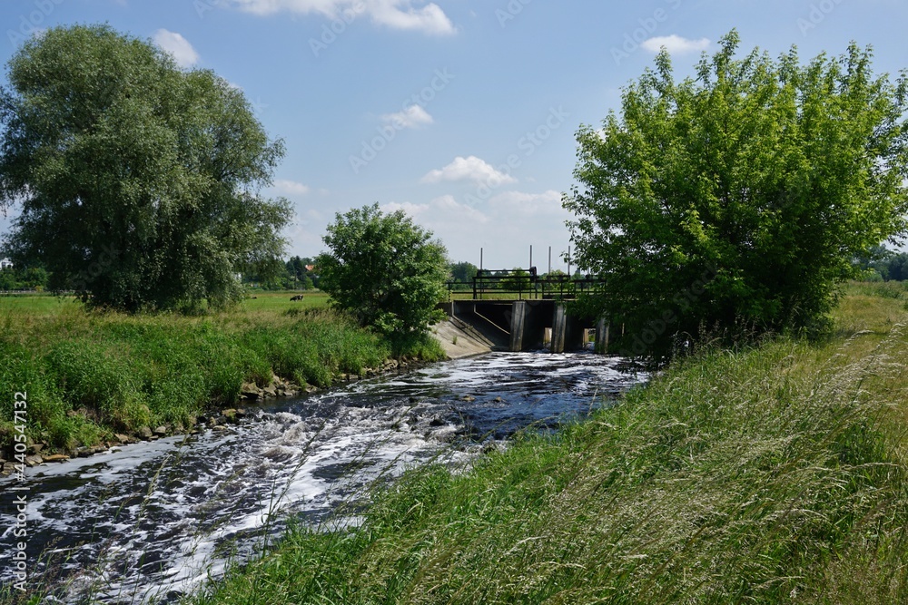 A small dam - water  tame  over the river