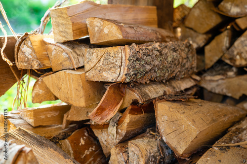 Woodpile of birch firewood. Procurement and storage of fuel for the winter