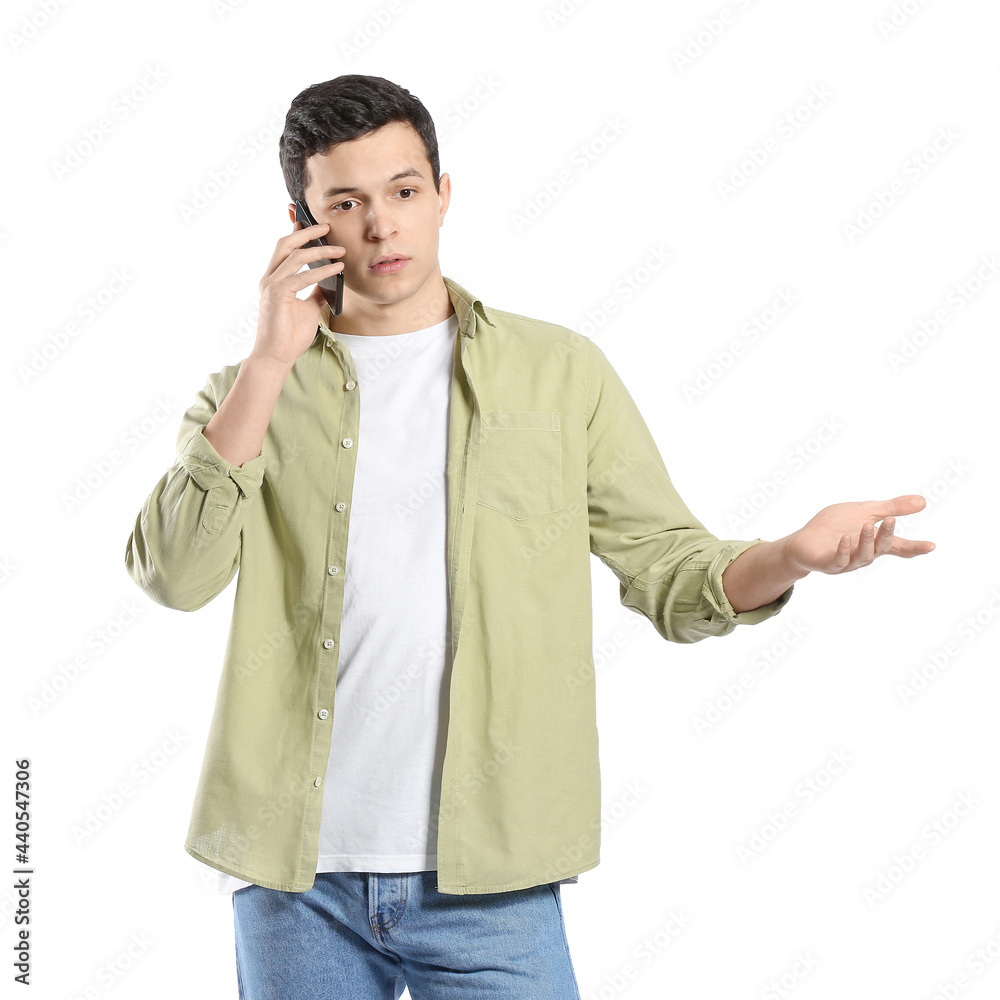 Young man talking by mobile phone on white background Young man talking by mobile phone on white background