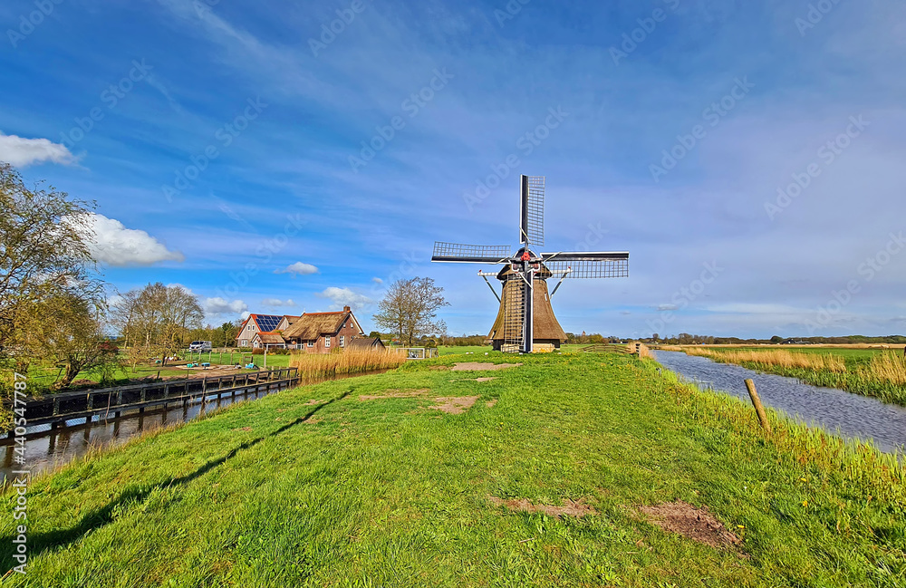 Oudkerker windmill in the countryside from the Netherlands Oudkerker windmill in the countryside from the Netherlands