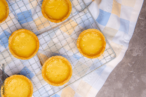 The egg tart  is a kind of custard tart found in Cantonese cuisine derived from the English custard tart and Portuguese pastel de nata. Egg tarts are often served at dim sum restaurants and cha chaan  photo