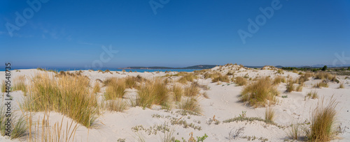 Fototapeta Naklejka Na Ścianę i Meble -  The wonderful white sand dunes of Porto Pino in Sardinia, Italy. Wild and uncontaminated environment. Tourist destination. Wonders of nature