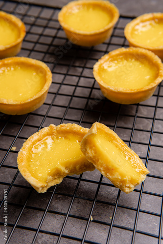 The egg tart  is a kind of custard tart found in Cantonese cuisine derived from the English custard tart and Portuguese pastel de nata. Egg tarts are often served at dim sum restaurants and cha chaan  photo