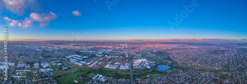 Panoramic aerial Drone view of Melbournes suburbs and CBD looking down at Houses roads and Parks Victoria Australia