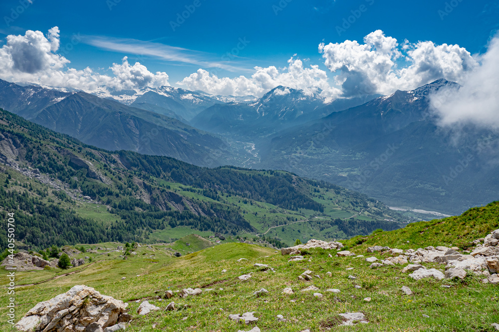 Springtime scenic view of the mountains in the Alps with emerging plant life and diminishing snow capped peaks Springtime scenic view of the mountains in the Alps with emerging plant life and diminishing snow capped peaks