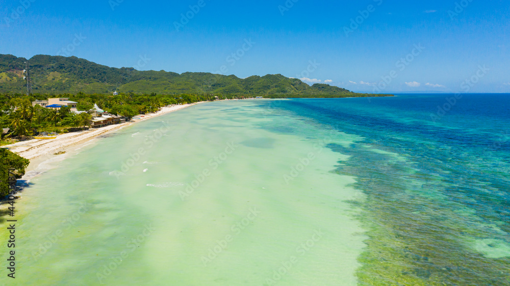 Obraz premium Tropical landscape: island with beautiful beach, palm trees by turquoise water. Bohol, Anda, Philippines. Summer and travel vacation concept.