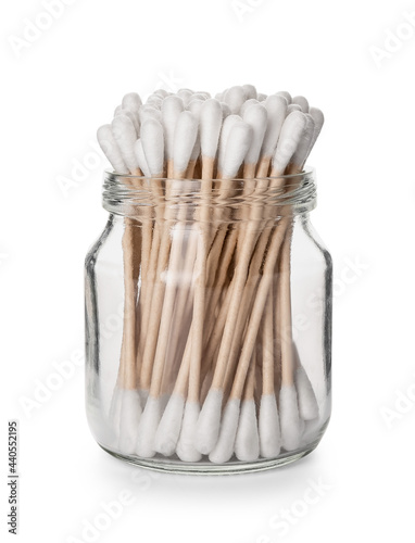 Glass jar with cotton swabs on white background photo