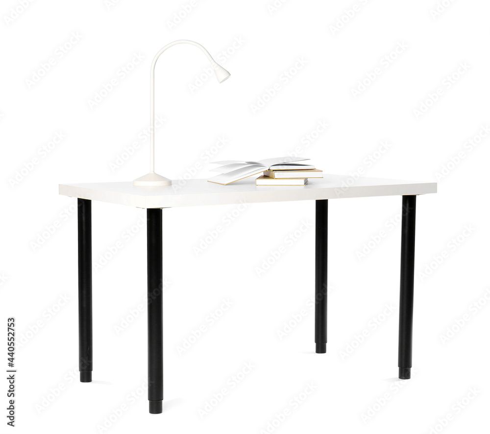 Stylish table with modern lamp and books on white background Stylish table with modern lamp and books on white background
