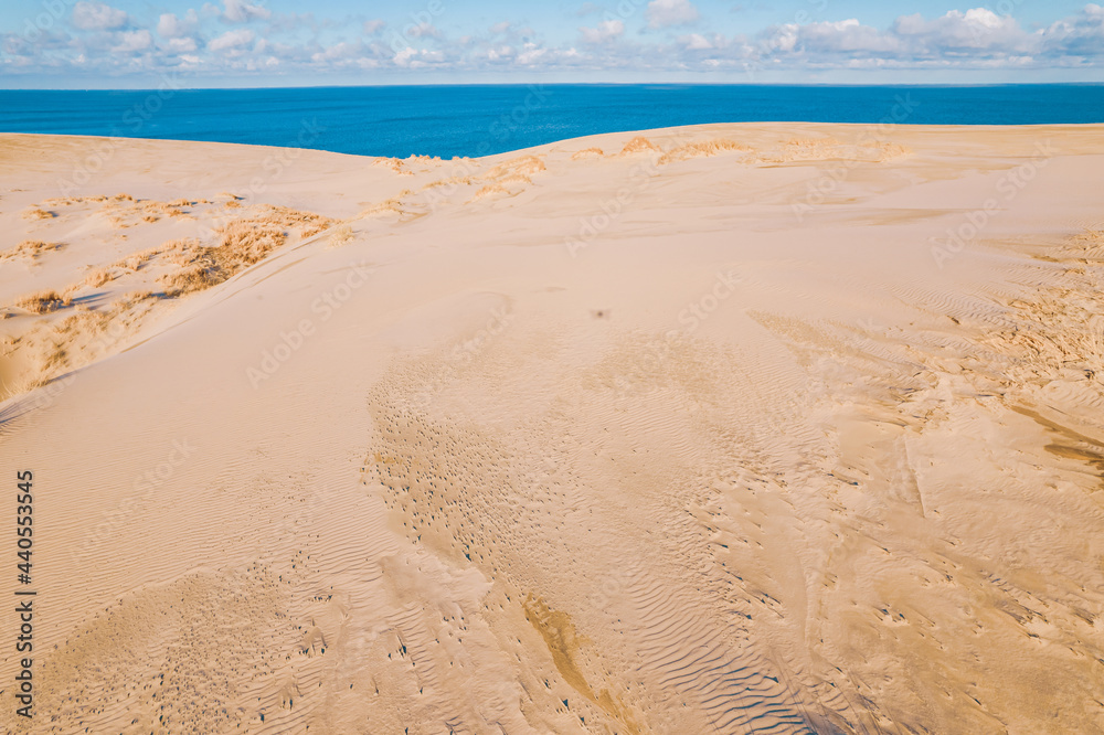 Border between sand desert and salty sea, aerial top view