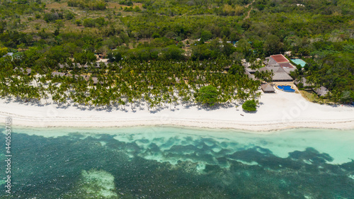 Tropical sandy beach with palm trees and turquoise clear waters. Panglao island, Bohol, Philippines. photo