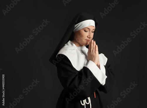 Mature nun on dark background