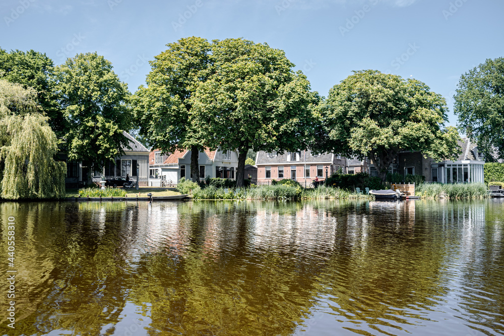 Dutch houses in the typical Dutch town Broek in Waterland, the Netherlands Dutch houses in the typical Dutch town Broek in Waterland, the Netherlands