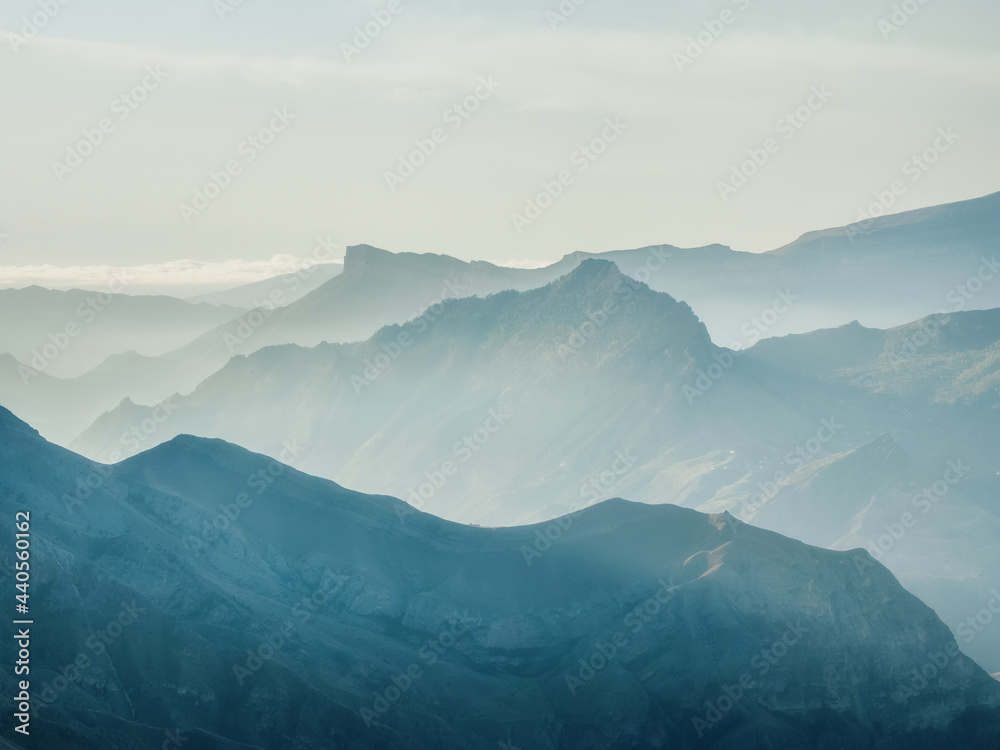 Silhouette of the mountains. Foggy layered mountain landscape.