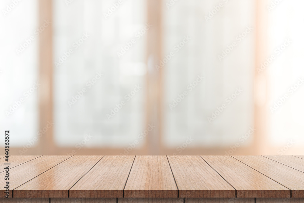 Empty wooden table top with lights bokeh on blur restaurant background.