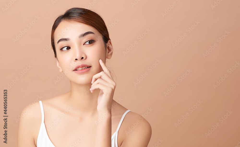 Beautiful young asian woman with clean fresh skin on beige background, Face care, Facial treatment, Cosmetology, beauty and spa, Asian women portrait. Beautiful young asian woman with clean fresh skin on beige background, Face care, Facial treatment, Cosmetology, beauty and spa, Asian women portrait.