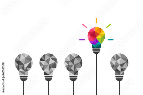 Colorful light bulb being different and standing out from the rest. Stand out and think differently concept. Creative and unique thinking, idea symbol. photo