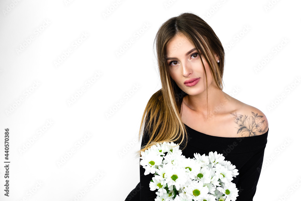 beautiful girl with a bouquet of flowers in a black jumpsuit bodysuit on a white background beautiful girl with a bouquet of flowers in a black jumpsuit bodysuit on a white background