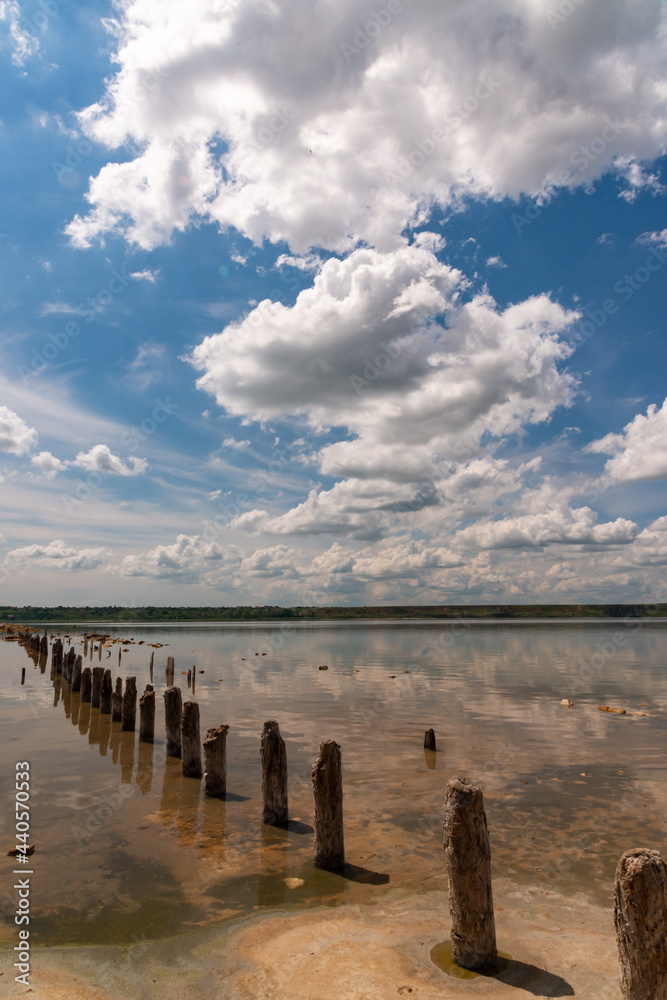 Large white clouds are reflected in the salt water of the Kuyalnitsky estuary, Ukraine. Large white clouds are reflected in the salt water of the Kuyalnitsky estuary, Ukraine.