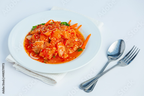 Salmon salad in a plate placed on a white background