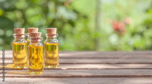 essential oil bottles in the nature blurred background with copy space	