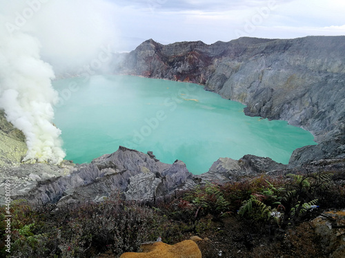 Landscape Kawah Ijen volcano and sulfur lake is composite volcanoes in the Banyuwangi Regency of East Java, Indonesia, Kawah ijen have Blue fire crater and Sulfur mining. Blue Nature Travel Background