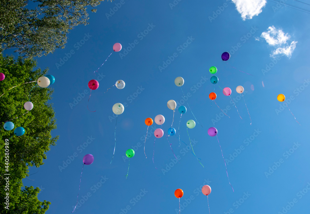 balls of different colors on blue sky