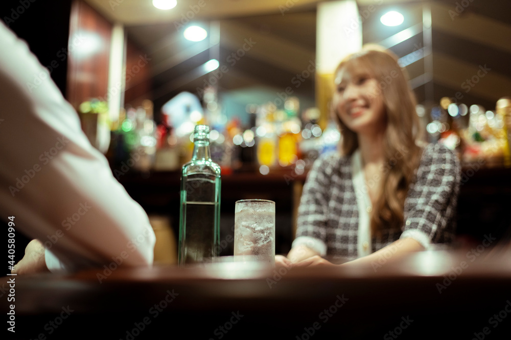 カウンターバーでお酒を提供する若い女性 カウンターバーでお酒を提供する若い女性