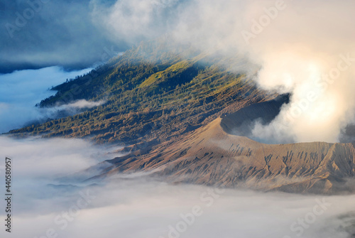 Bromo Mountain is an active volcano and part of the Tengger massif, in East Java, Indonesia. The volcano belongs to the Bromo Tengger Semeru National Park.hikes to epic mountains and adventurous back photo