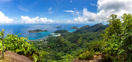 Panorama of Mahe Island, Seychelles, coastline from Morne Blanc View Point with lush tropical vegetation, crystal blue ocean and small tropical islands.
