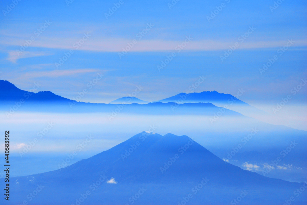 Rinjani Mountain Landscape and Cloude blue sky in the morning with fog and misty around the Valley. View from Bromo Mountain at Bromo tengger semeru national park , Indonesia - Blue Nature Abstract