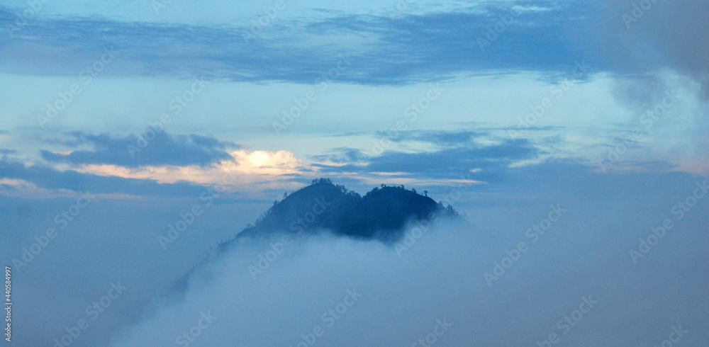 Top of Mountain with misty or fog around mountain at kawah ijen volcano , indonesia