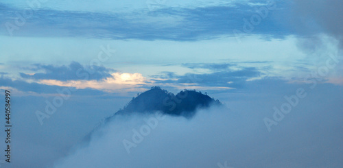 Top of Mountain with misty or fog around mountain at kawah ijen volcano , indonesia