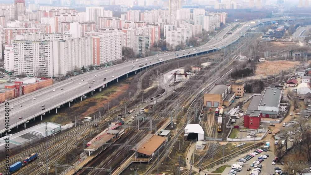 Large settlement. Railway tracks near the city. Lots of vehicles top view in the days Large settlement. Railway tracks near the city. Lots of vehicles top view in the days