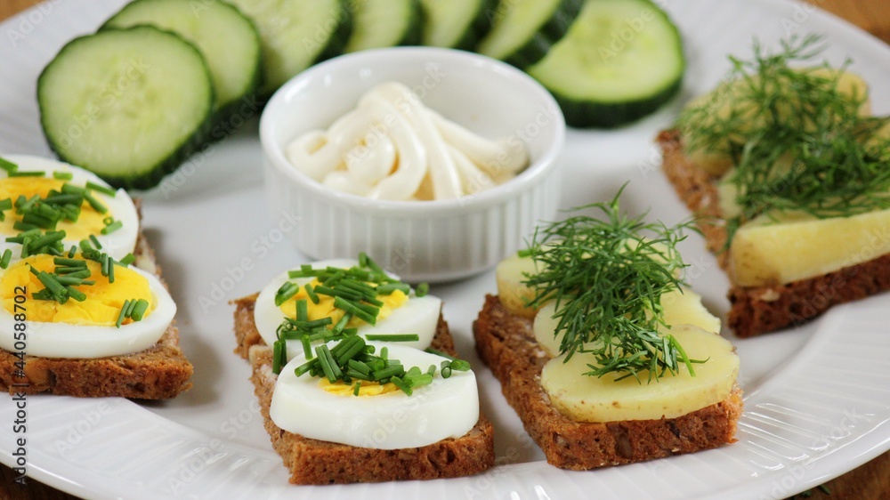 traditional danish open sandwich with egg, chives and popato, dill ( smørrebrød )