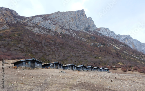 Landscape of Luorong Pasture with  House for rest for trekking to see milk lake at Daocheng County,Sichuan Province, China  photo