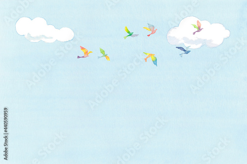 虹色の鳥の群れと青空