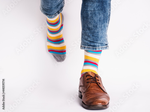 Men's legs, trendy shoes and bright socks. Close-up. Style, beauty and elegance concept