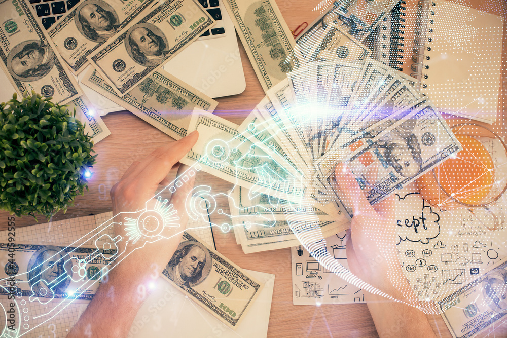 Multi exposure of Tech drawing hologram and USA dollars bills and man hands. Technology concept. Multi exposure of Tech drawing hologram and USA dollars bills and man hands. Technology concept.