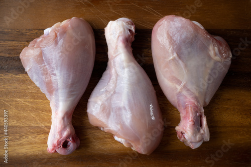 raw uncooked skinless chicken leg photo