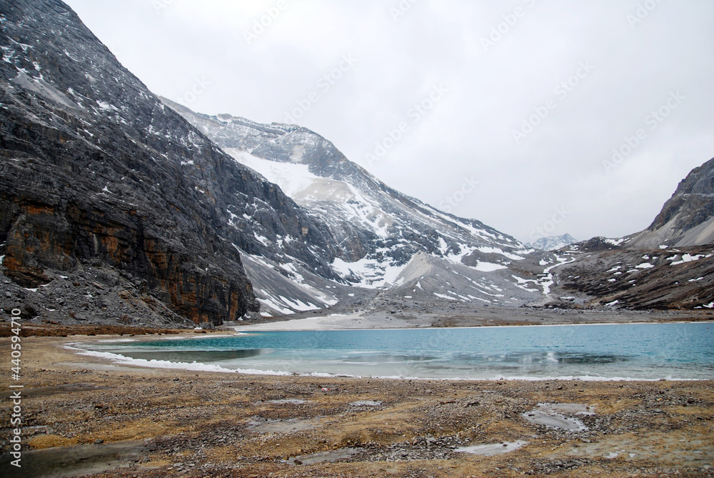 Landscape nature Milk Lake at yading china. Milk Lake is a stunning glacier fed blue lake on the south end of Mt. Chenresig , Daocheng Country,China - hikes to epic mountains and adventure backpack