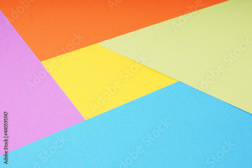 multicolor paper background with 5 different colors in triangle and rhombus shapes