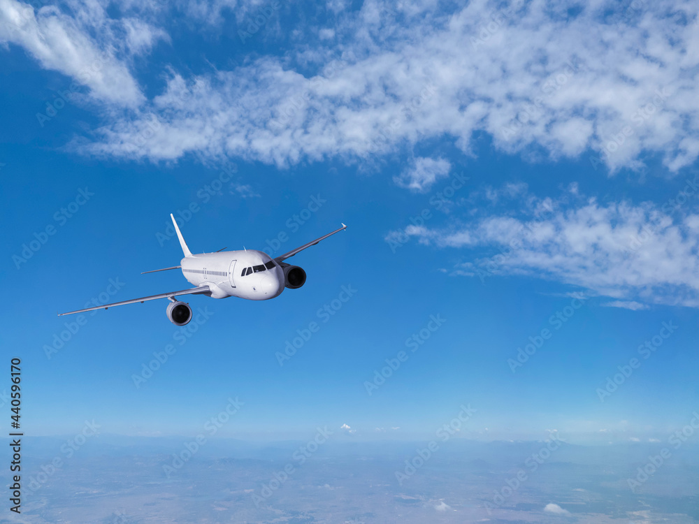 Fototapeta premium Airplane flying in the blue sky 