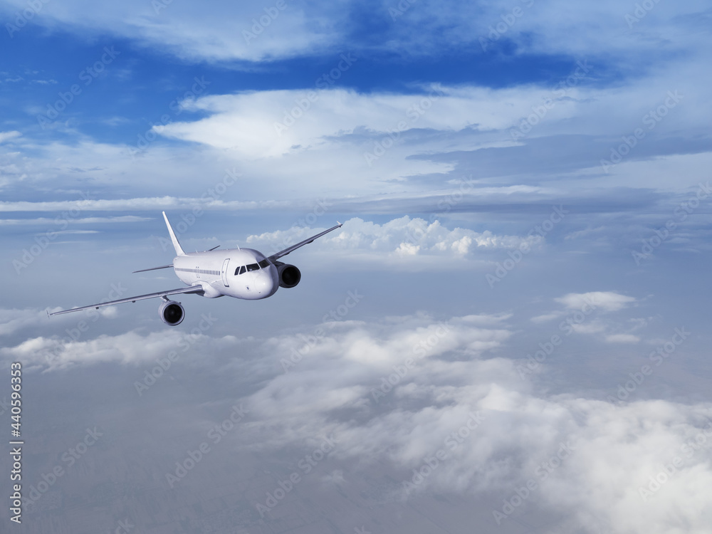 Obraz premium Airplane flying in the blue sky