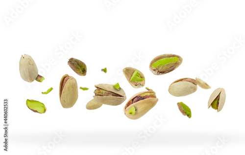 Crushed pistachios close-up hovered in white space